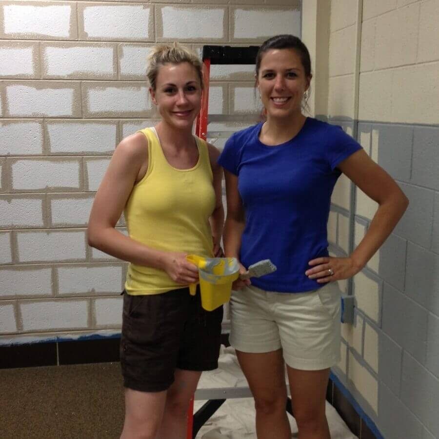 Anna and Becky helping to paint a school